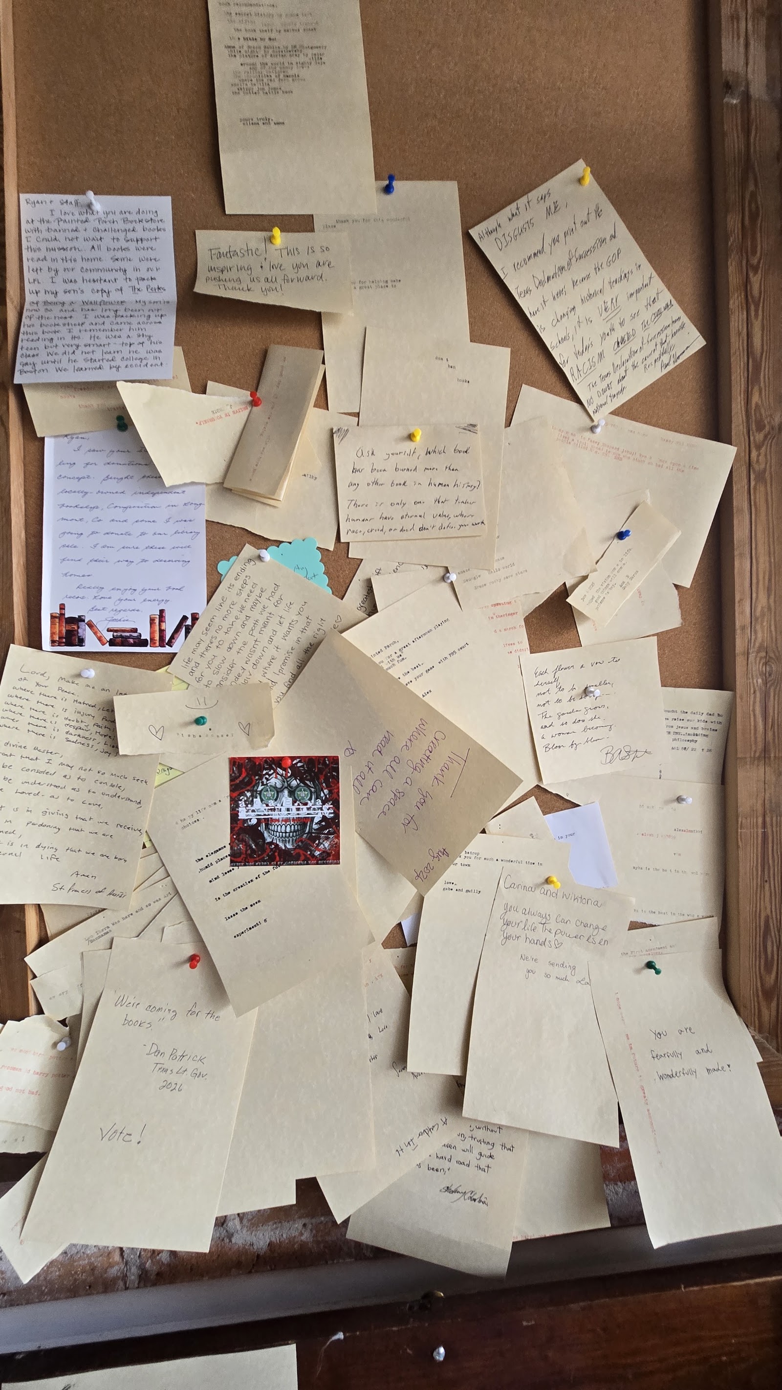 A wall of handwritten cards left by visitors about banned books that mattered to them