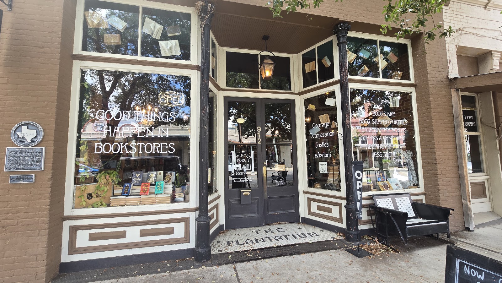 The Painted Porch storefront: 'Good things happen in bookstores' and the four Stoic virtues etched on the glass
